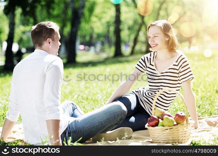 Weekend in park. Young couple in love having fun and enjoying the beautiful nature