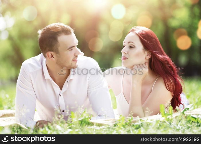 Weekend in park. Young couple in love having fun and enjoying the beautiful nature