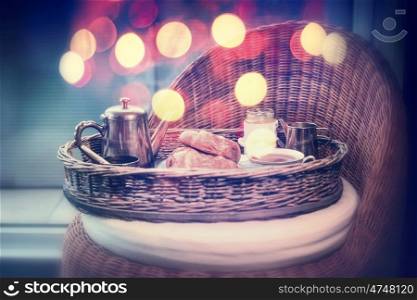 Weekend or holiday breakfast with vintage coffee pot and croissants, mug of coffee and bokeh