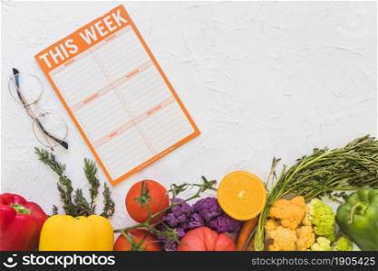 weekly meal plan with colorful fruits vegetables textured background. Beautiful photo. weekly meal plan with colorful fruits vegetables textured background