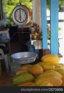 Weighing scale over a heap of papayas at a market stall, Providencia, Providencia y Santa Catalina, San Andres y Providencia Department, Colombia