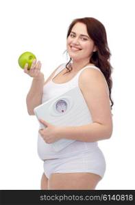 weight loss, diet, slimming, healthy eating and people concept - happy young plus size woman in underwear holding scales and green apple