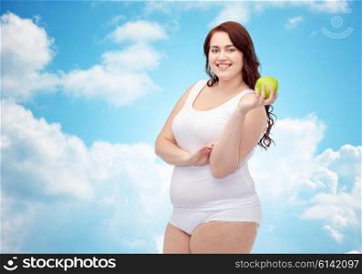 weight loss, diet, slimming, healthy eating and people concept - happy young plus size woman in underwear with green apple over blue sky and clouds background