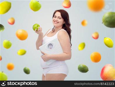 weight loss, diet, slimming, healthy eating and people concept - happy young plus size woman in underwear holding scales and green apple over gray background with fruits