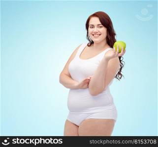 weight loss, diet, slimming, healthy eating and people concept - happy young plus size woman in underwear with green apple over blue background