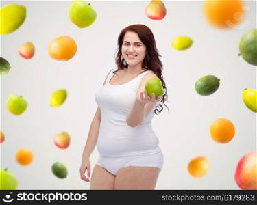 weight loss, diet, slimming, healthy eating and people concept - happy young plus size woman in underwear with green apple over fruit background