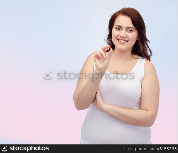 weight loss, diet, slimming, medicine and people concept - happy plus size woman in underwear with pill over rose quartz and serenity gradient background