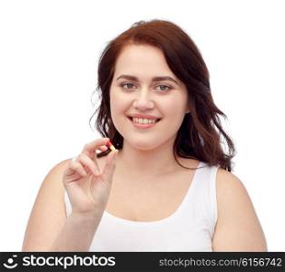 weight loss, diet, slimming, medicine and people concept - happy plus size woman in underwear with pill