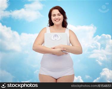 weight loss, diet, slimming, plus size and people concept - happy young plus size woman in underwear holding scales over blue sky and clouds background