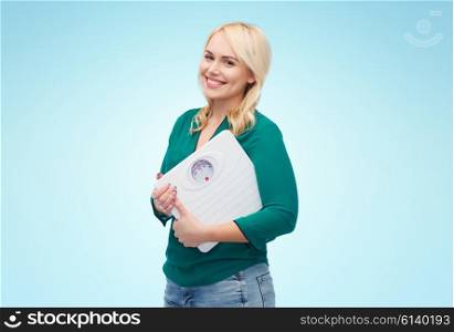 weight loss, diet, slimming, plus size and people concept - smiling young woman holding scales over blue background
