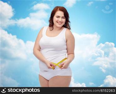weight loss, diet, slimming, size and people concept - happy young plus size woman in underwear measuring tape over blue sky and clouds background
