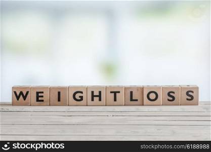 Weightloss sign with wooden cobes in a bright room