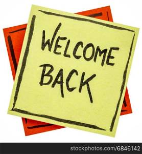welcome back on a sticky note. welcome back - handwriting on a sticky note isolated on white