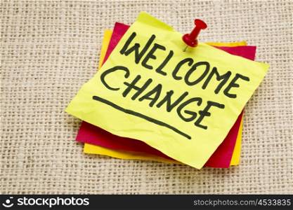 welcome change - advice on a sticky note against burlap canvas