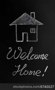 Welcome home written with chalk on a blackboard