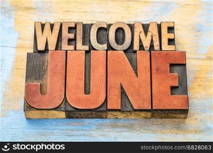 Welcome June banner - word abstract in vintage letterpress wood type blocks