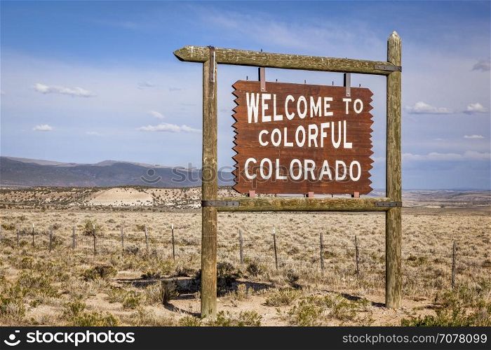 welcome to Colorado roadside wooden sign at a border with Utah in northwestern Colorado