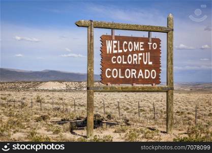 welcome to Colorado roadside wooden sign at a border with Utah in northwestern Colorado
