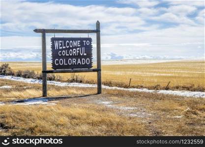 welcome to colorful Colorado roadside wooden sign at a border with Utah in Colorado in the Four Corner region in winter scenery