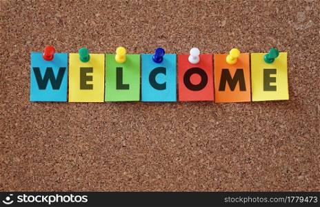 Welcome word and sign on colorful paper notes pinned with multicolored push pins on a cork notice board welcoming concept background.