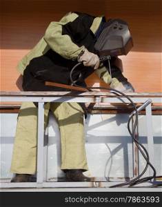 Welder in a special suit, while working in direct sunlight