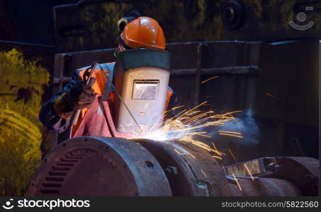 welder is welding a steel plate