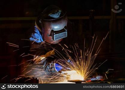 Welder is welding assembly automotive part in car factory