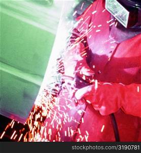 Welder welding a car door, Delaware, New York City, New York State, USA