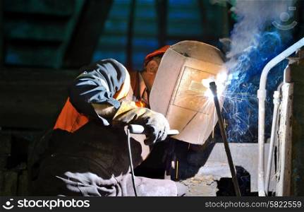 welder working in manufacture production plant