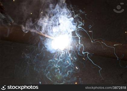 Welding steel pipe, bright light smoke spark electric arc