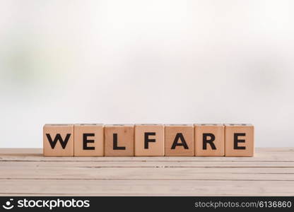 Welfare sign made of wooden cubes on a desk