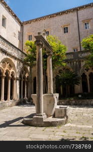 Well and cloisters of Franciscan Monastery in the old town of Dubrovnik in Croatia. Franciscan Monastery and Museum in Dubrovnik old town