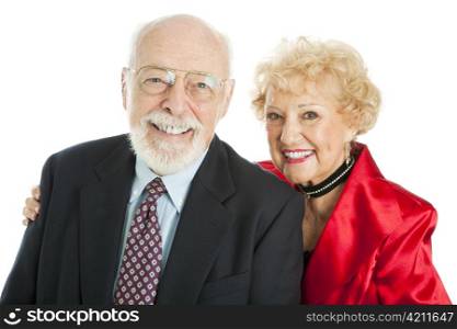 Well-dressed, successful senior couple smiling. Isolated on white.