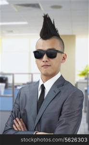 Well-dressed young man with Mohawk and sunglasses