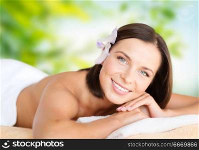 wellness and beauty concept - close up of beautiful woman at spa over green natural background. close up of beautiful woman at spa. close up of beautiful woman at spa