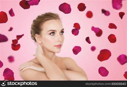 wellness and beauty concept - portrait of beautiful bare woman over red rose petals on pink background. beautiful bare woman over rose petals background. beautiful bare woman over rose petals background
