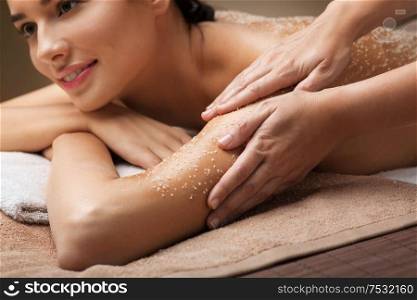 wellness, beauty and relaxation concept - close up of woman having salt massage at spa. close up of woman having salt massage at spa