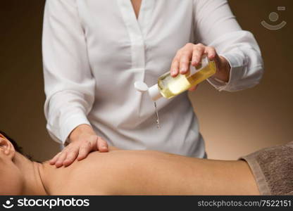 wellness, beauty and relaxation concept - close up of young woman lying and having back massage with oil at spa. close up of woman having back massage at spa