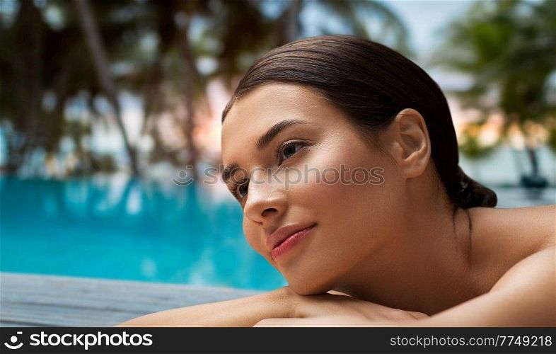 wellness, beauty and relaxation concept - young woman lying at spa over tropical beach background in french polynesia. young woman lying at spa or massage parlor
