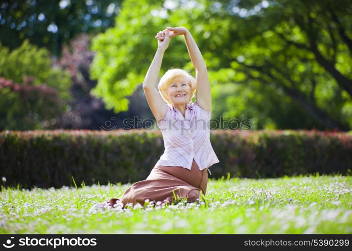Wellness. Mental Health. Optimistic Old Woman Exercising in Open Air