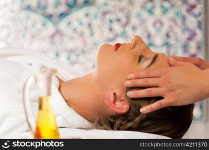 Wellness - woman getting massage in Spa; it is a massage for the head