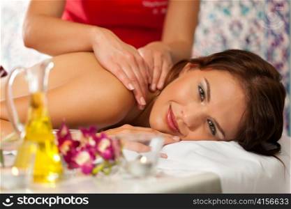 Wellness - woman getting massage in Spa; it is a traditional back massage