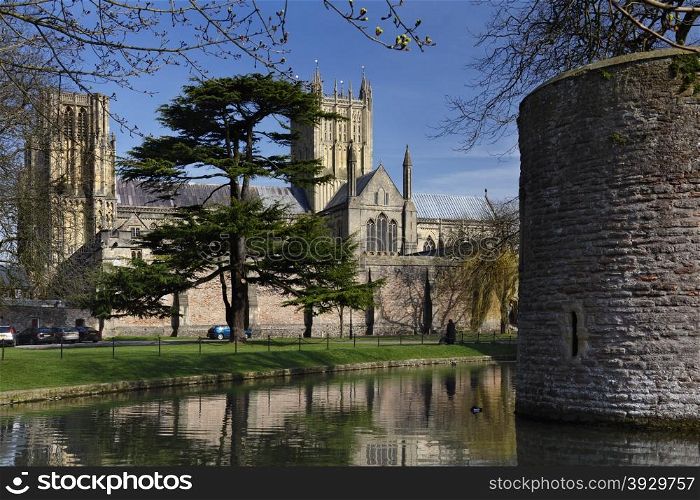 Wells Cathedral viewed over the moat of the Bishops Palace in the City of Wells in Somerset, England. circa 1100AD.