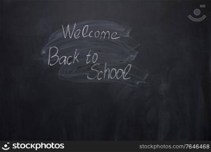 welocome back to school written with chalk words on blackboard. welcome back to school