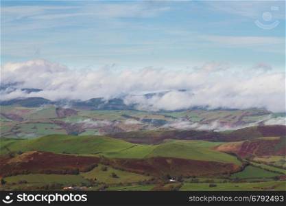 Welsh countryside with cloud clinging to hills in temperature inversion. Powys, Wales, United Kingdom.