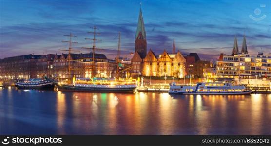 Weser River and St Martin Church, Bremen, Germany. Embankment of the Weser River and Protestant Lutheran Saint Martin Church in the old town of Bremen, Germany. Night panoramic view.