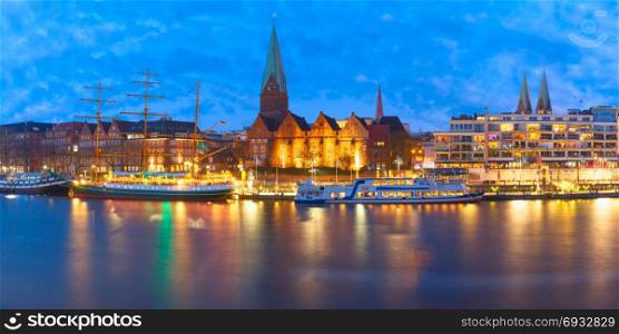 Weser River and St Martin Church, Bremen, Germany. Embankment of the Weser River and Protestant Lutheran Saint Martin Church in the old town of Bremen, Germany. Night panoramic view.