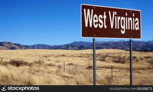 West Virginia road sign with blue sky and wilderness