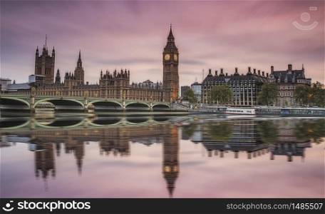 Westminster Abbey and Big Ben over the Thames in London with reflection on river