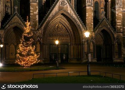 Westminster Abbey in London England with Christmas tree in front of side entrance